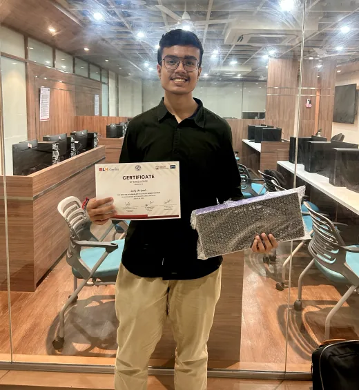 Arav holding his certificate of excellence and a boxed Kreo Hive keyboard after Gemini Hackdays 2026