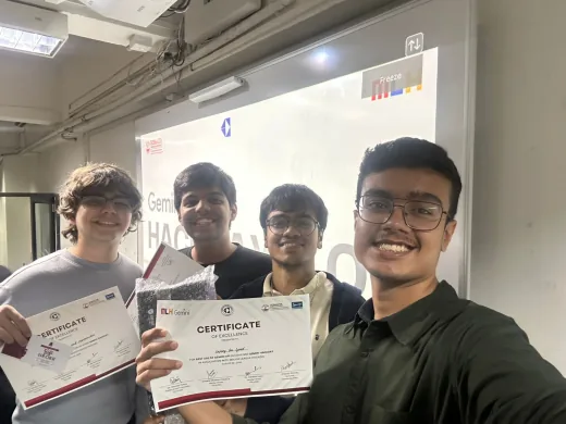 Arav and three teammates holding their Gemini Hackdays certificates in front of the event screen