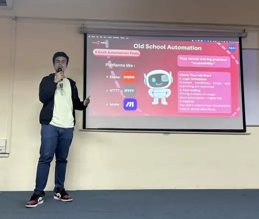 Arav presenting a slide comparing Zapier, IFTTT and Make during a talk on automation