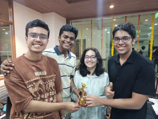 Arav and three teammates holding the first place trophy from The What Factor hackathon